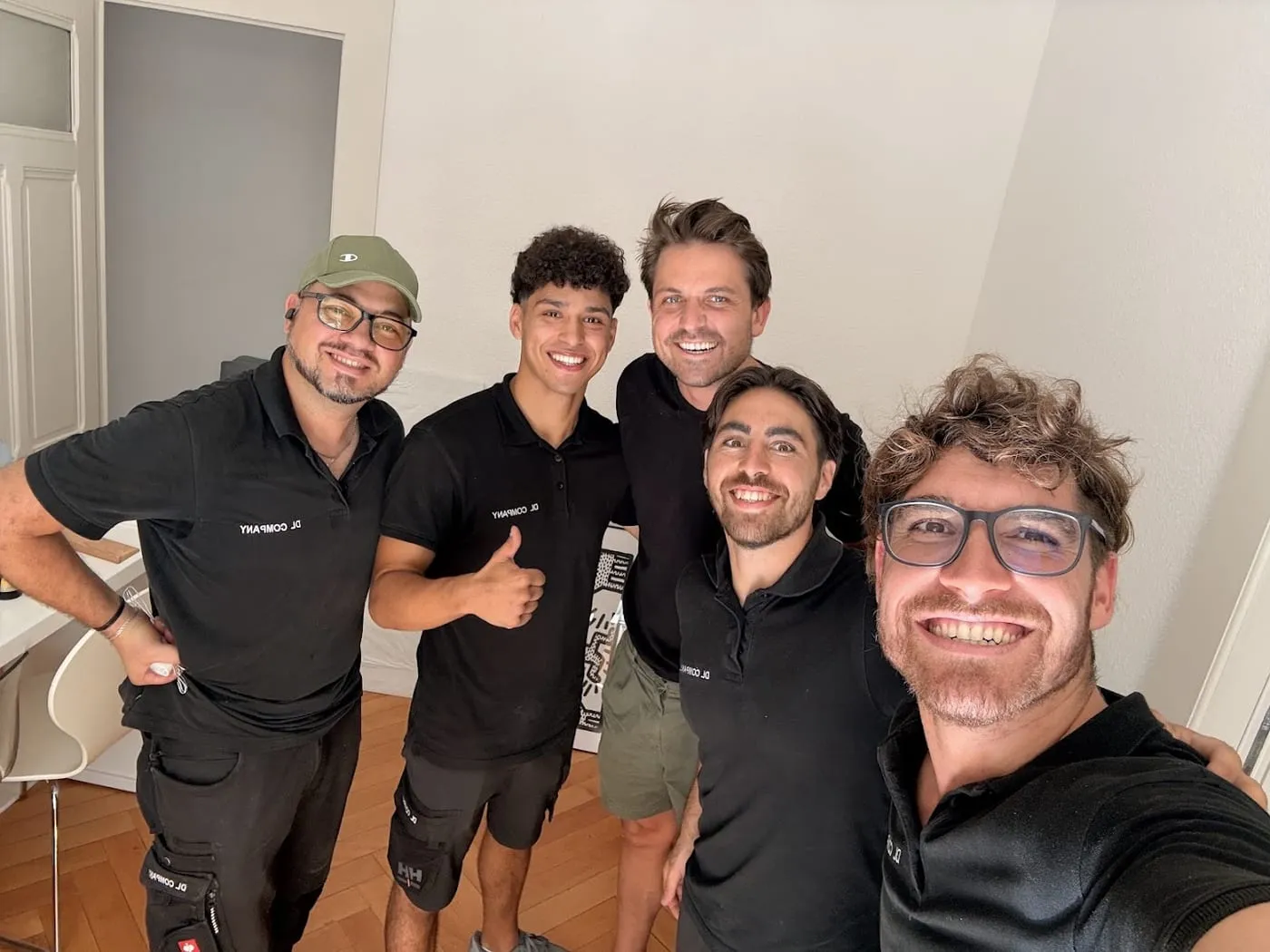 L’équipe DL Company en tenue noire, sourire aux lèvres